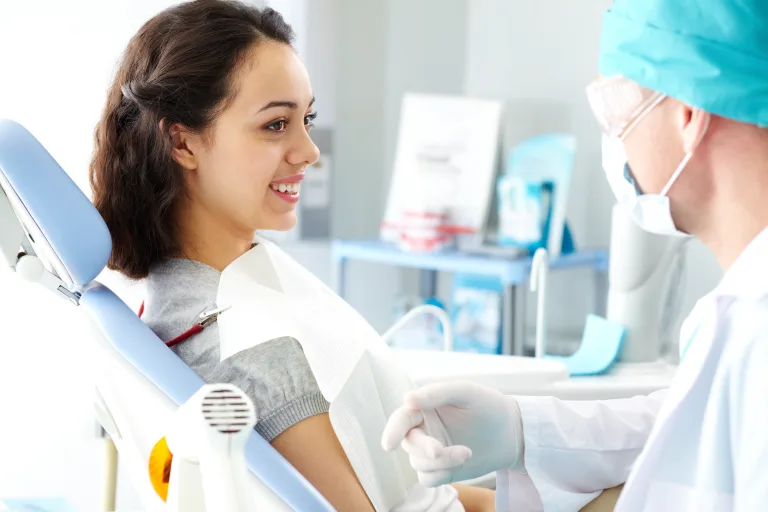 Young Female Teen in Dental Chair After Tooth Extraction